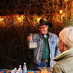 WMG's Cultural Ecologist Joaquin Murrieta-Saldivar holds a pitcher at Rainwater on Tap.