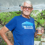 Docent Art holds down the beverage tent.