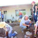Workshop attendees are digging basins that will passively capture rainwater, and are lining the basins with rocks so the basins do not erode during a heavy rain. Photo: Jamie Manser/Watershed Management Group