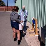 Jean Fedigan, executive director of the Sister Jose Women’s Shelter located at 1050 S. Park Ave., shows the “Tippy tap” hand wash station to a woman.
