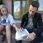Catlow Shipek, a senior program manager with Watershed Management Group, sketches a possible water harvesting and landscape plan after a consultation.