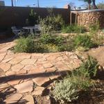 One of two water-harvesting storage tanks at Kay Baumann’s home. It matches the flagstones, rock planters.
